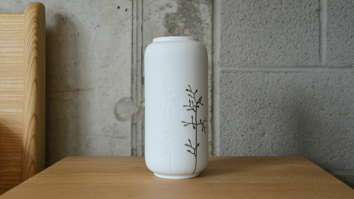 porcelain vase with imprinted floral design and gold detail