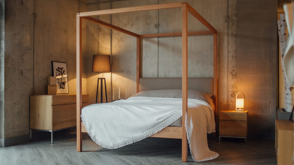 Porto white cotton bedspread draped on our classic 4 Poster Highland bed with upholstered headboard