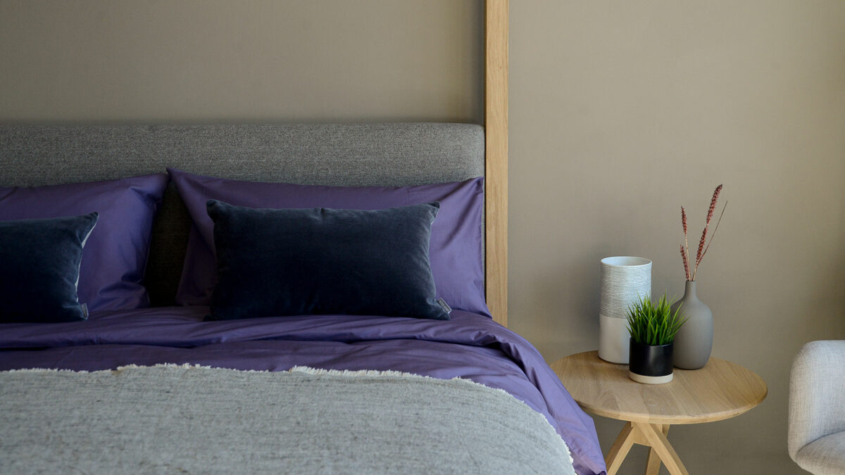 purple egyptian cotton bedding with oak twist table