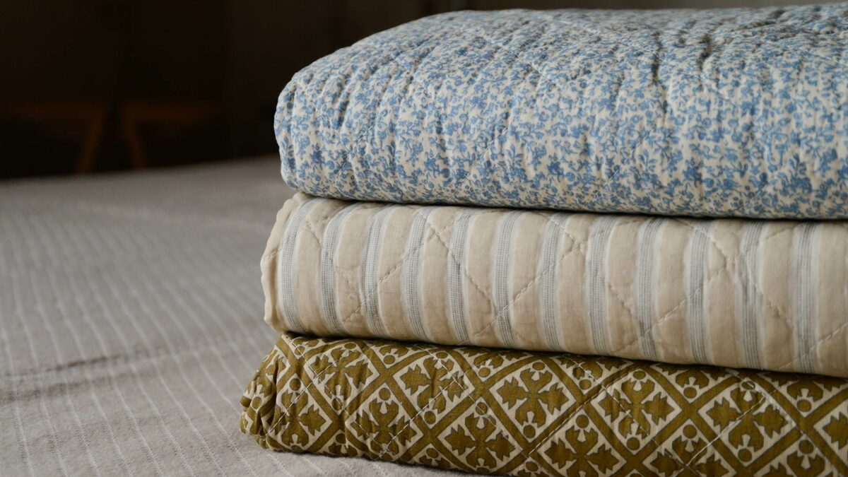 quilted cotton throws in blue and gold patterns