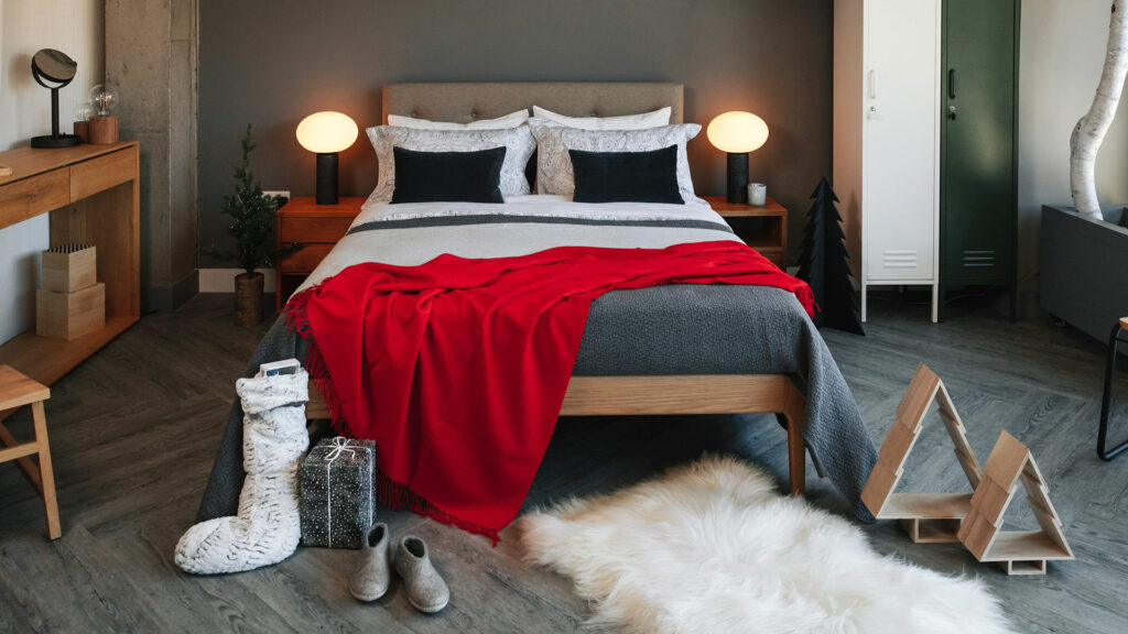 Christmas bedroom textures of grey and a striking red luxury throw