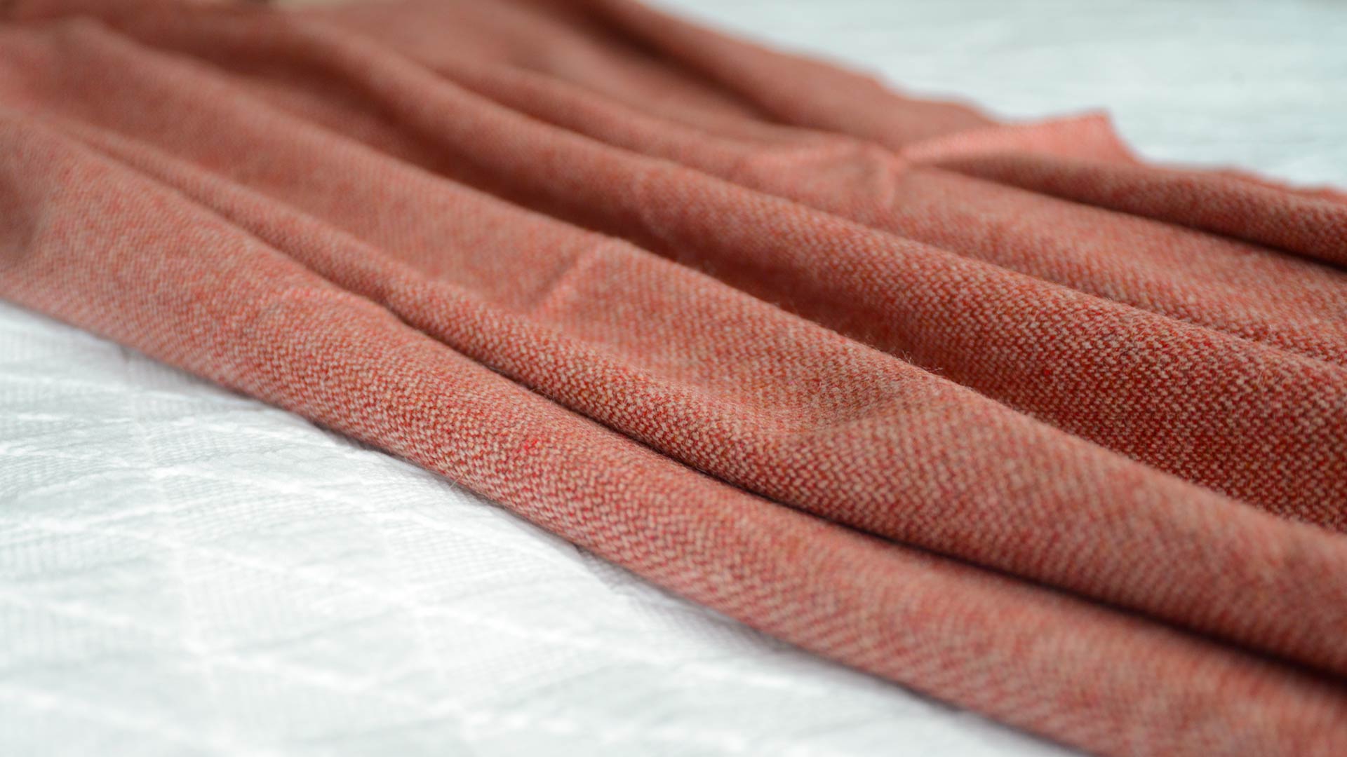 recycled wool throw with tweed effect red and beige weave.