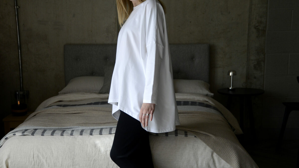 relaxed white top with longer back hem