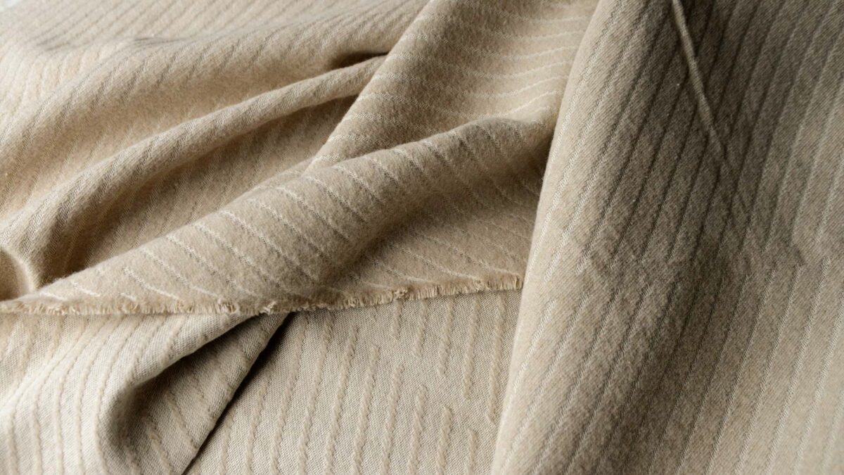 soft cotton striped bedspread in beige shown in close up