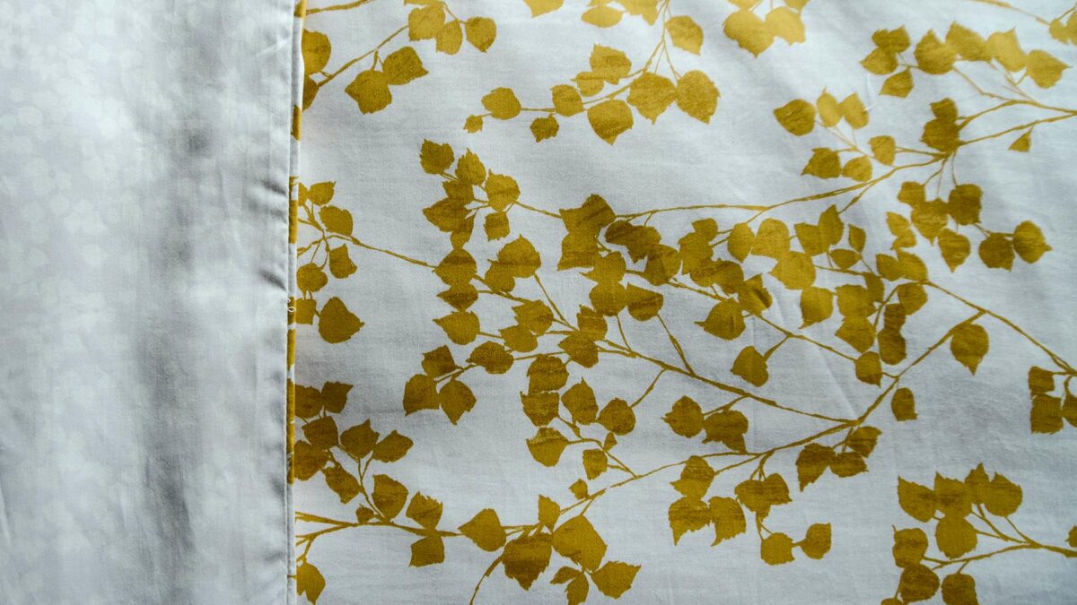 reversible leaf print duvet cover set in mustard yellow and white a close up view