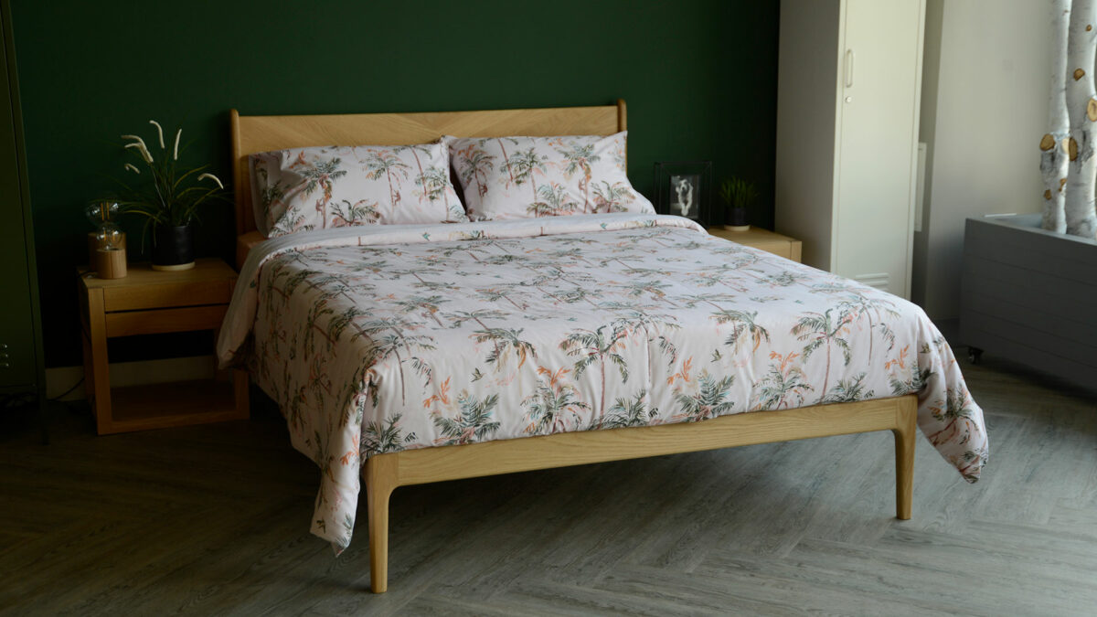 blush pink duvet set with palm tree print shown on an Oak Hoxton bed