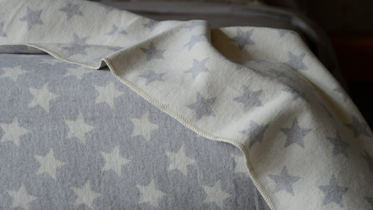 soft touch reversible star patterned cotton-rich blanket in grey and ivory