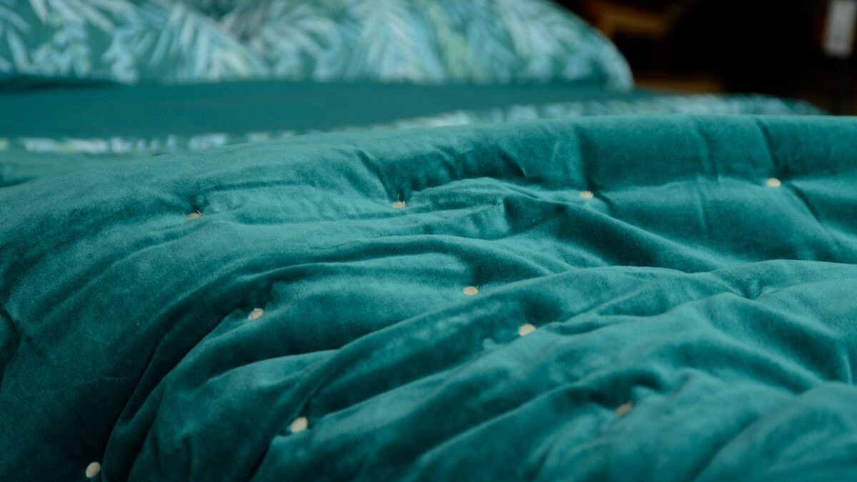 teal coloured velvet quilt with cotton fabric reverse