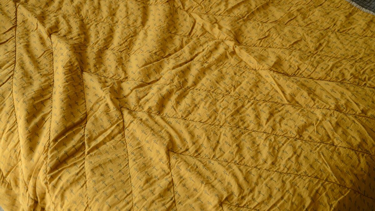 reversible throw with chevron quilting detail