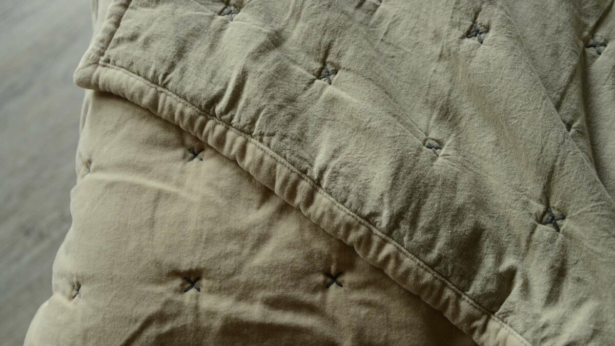 Pale buff colour velvet bedspread with stitch detail