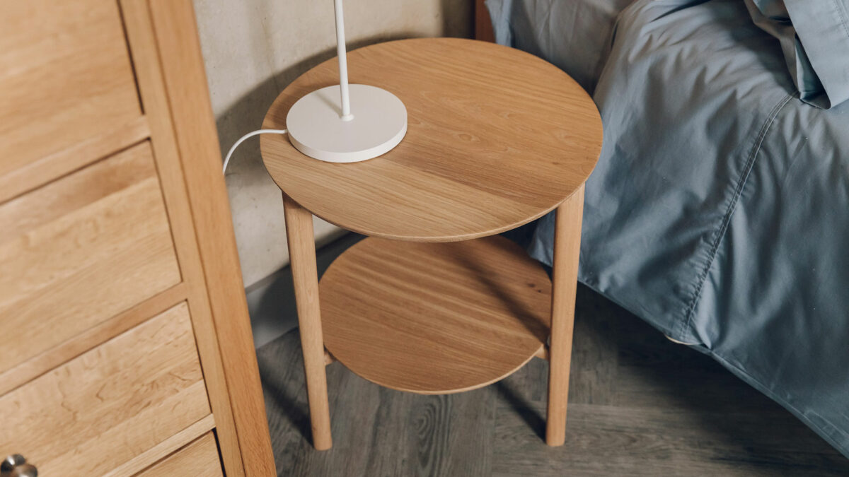 circular side table with lower shelf and made from oak