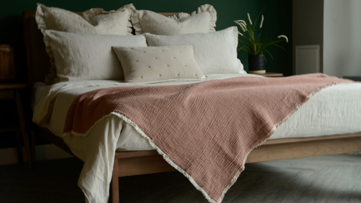 organic cotton reversible throw in blush pink and ivory