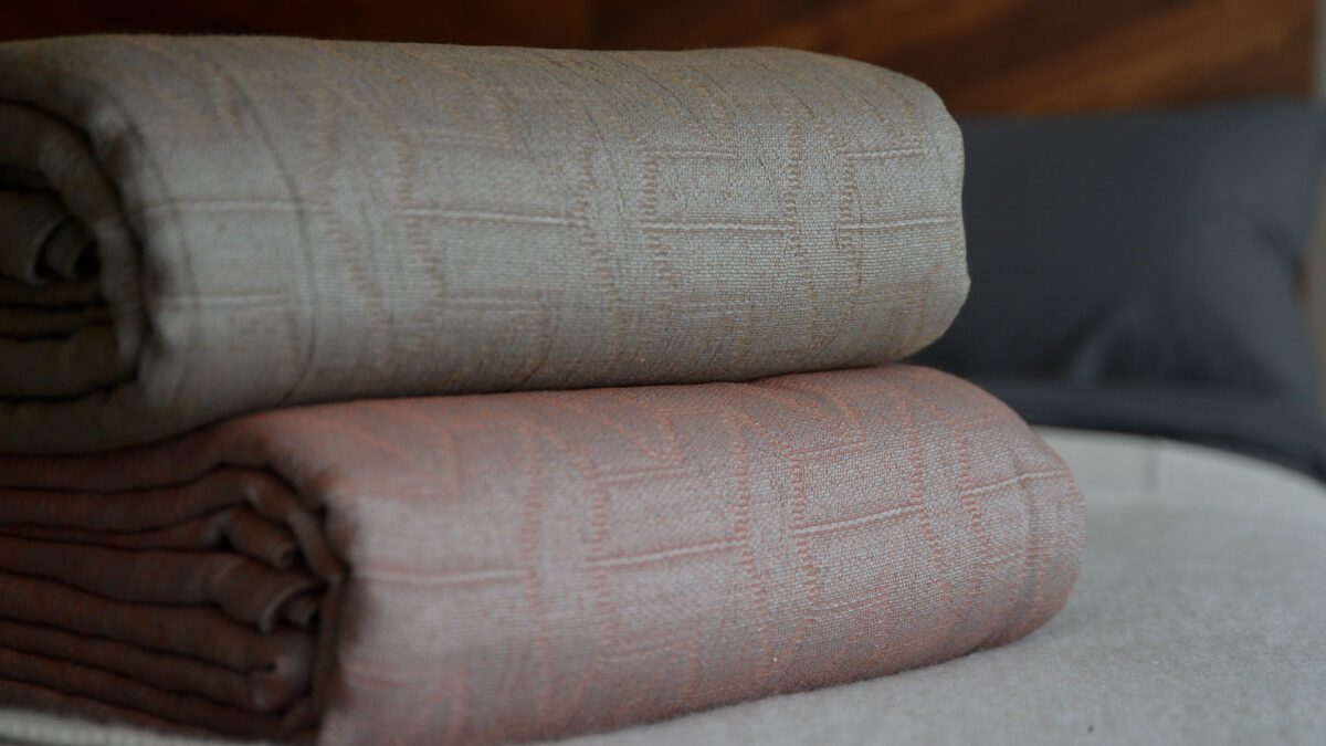 textured pattern lightweight cotton rich bedspreads in a rust red or mushroom colour