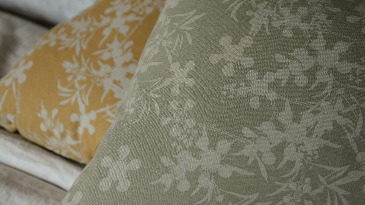 floral print cushions in a choice of sage green or deep yellow on pale stone