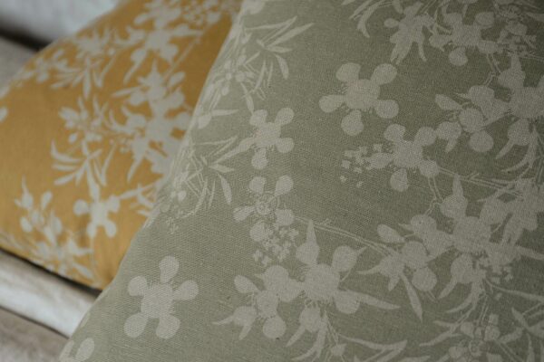 floral print cushions in a choice of sage green or deep yellow on pale stone