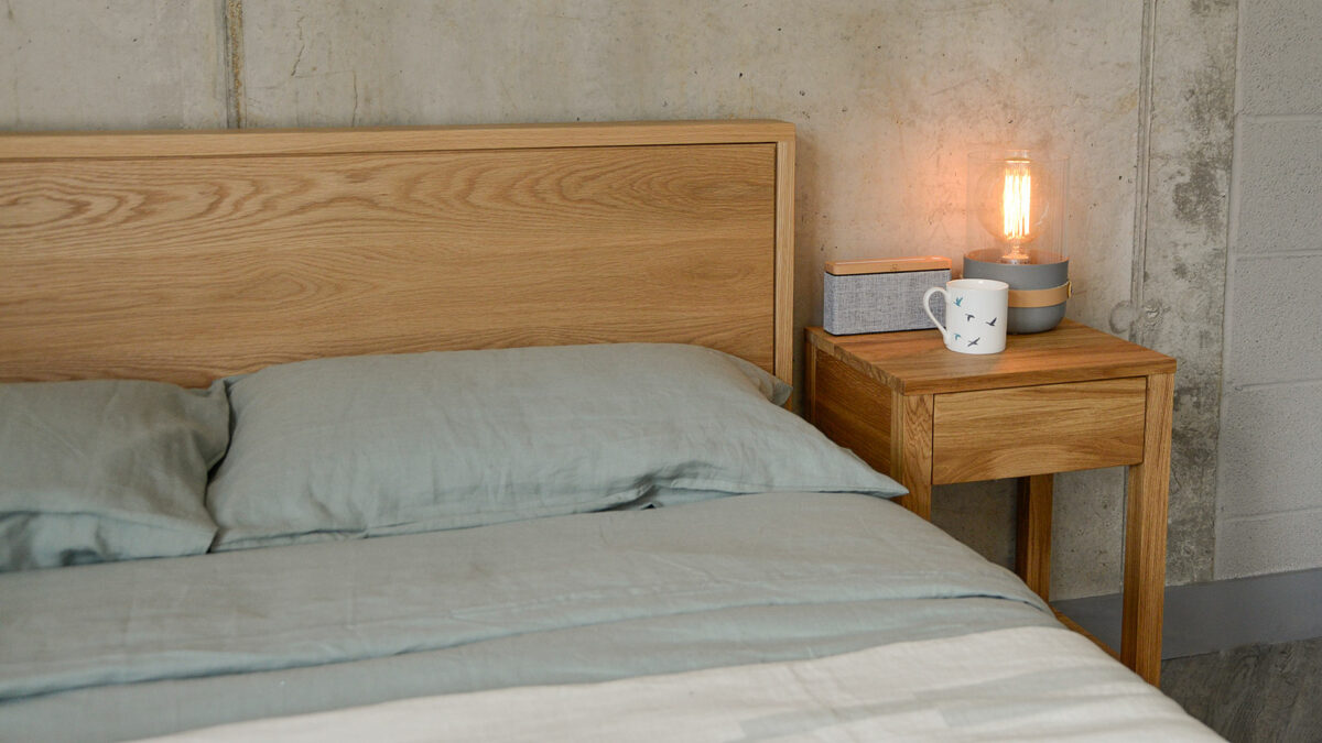 sage green bedding on oak leith with solid oak side table