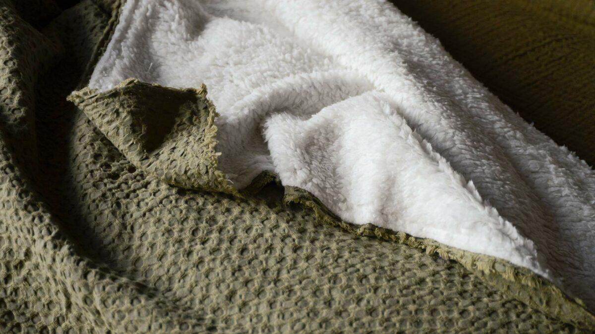 sage green blanket with white fleece back
