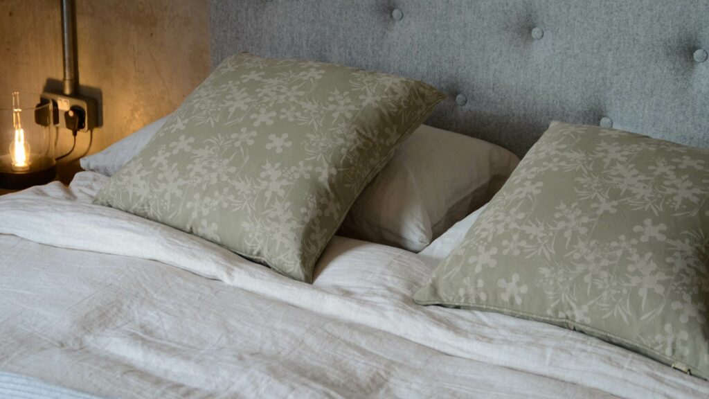 sage green and stone coloured floral print cushions