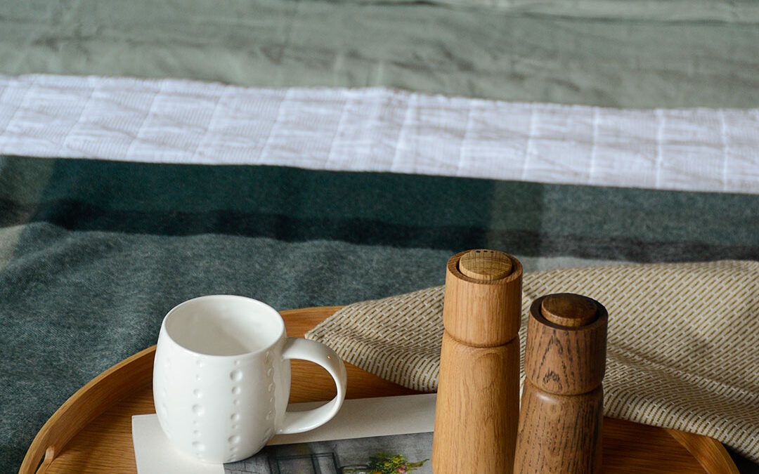 salt and pepper grinder tray on bed portrait