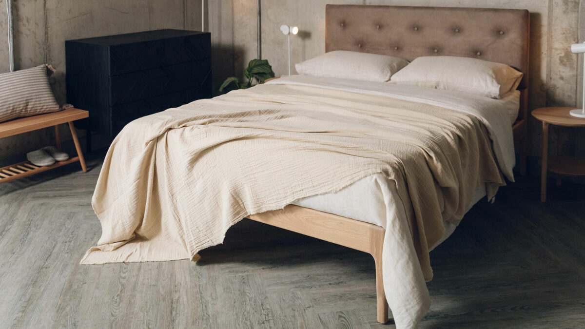 lightweight crinkle texture sand coloured bedspread shown on a kingsize bed