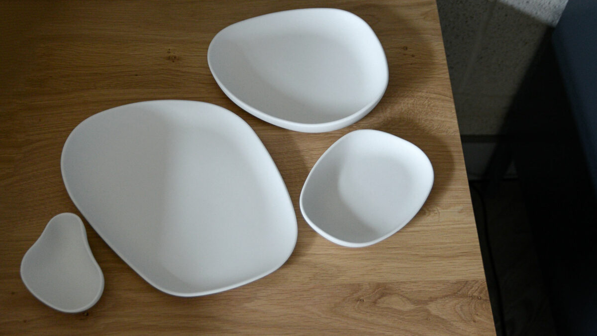 a set of irregular shaped modern plates and dishes in matt white porcelain