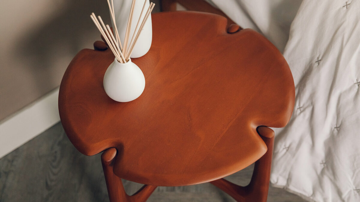 retro inspired deep toned mahogany side table a view of the shaped top and legs