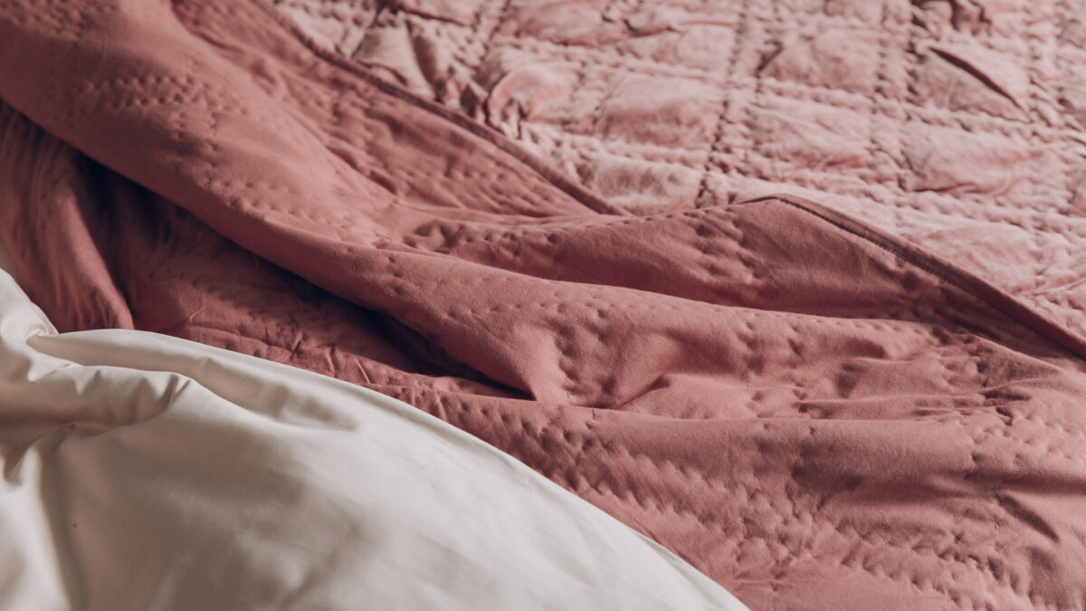 dusky rose quilted velvet bedspread shown close up