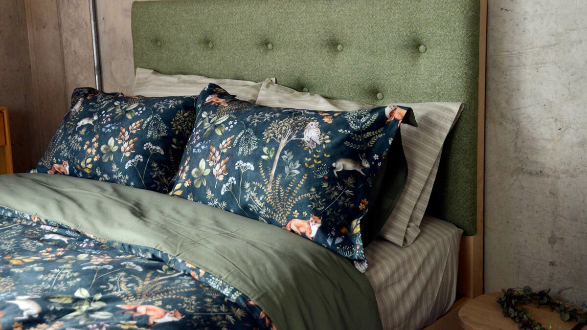 Autumnal colours Woodland print duvet cover set shown on a kingsize upholstered bed