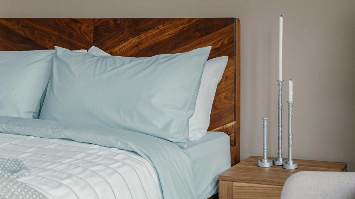 silver colour candle holders with mint colour bedding