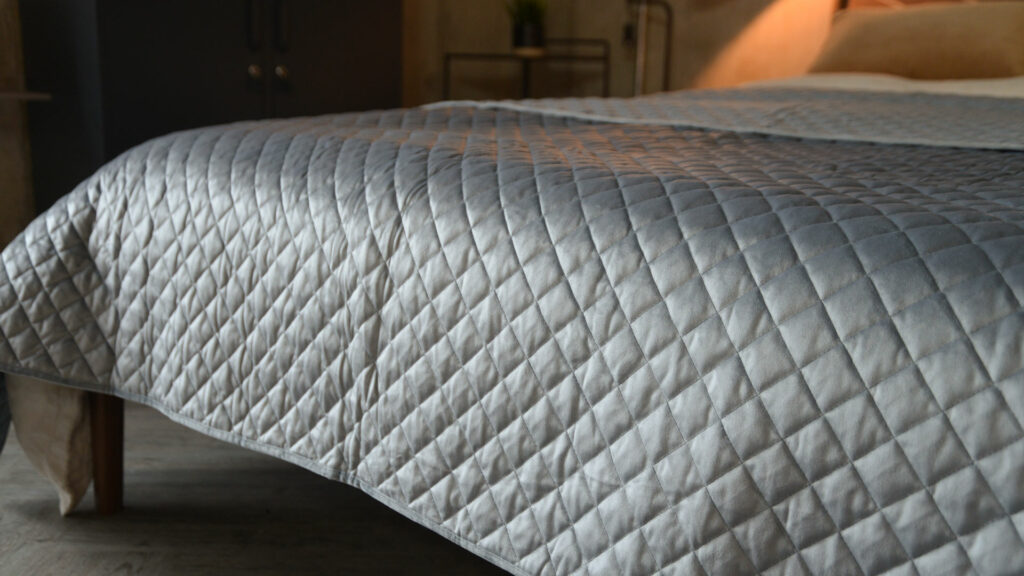 Silver grey velvet look quilted and reversible bedspread a closer view