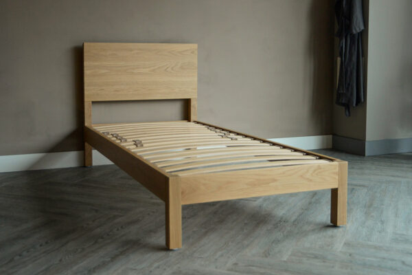 solid oak single bed shown without mattress