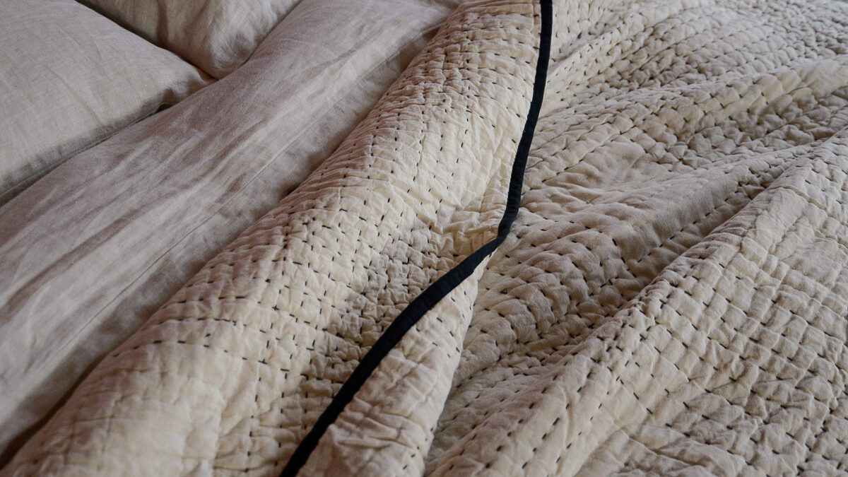 sitched beige bedspread close up rumpled