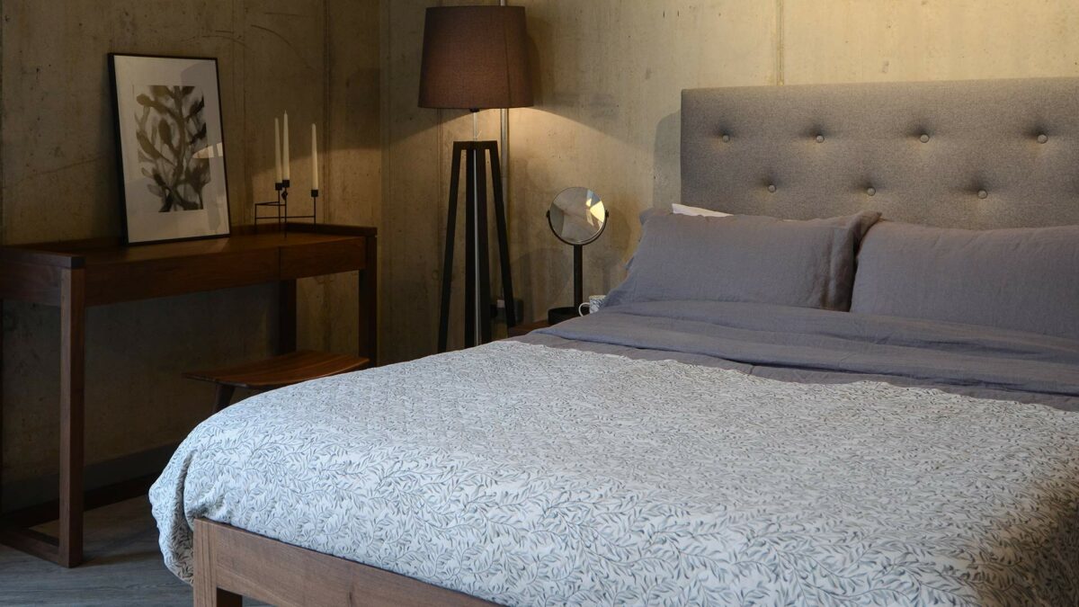 skye tall padded headboard bed with a walnut frame and grey linen bedding