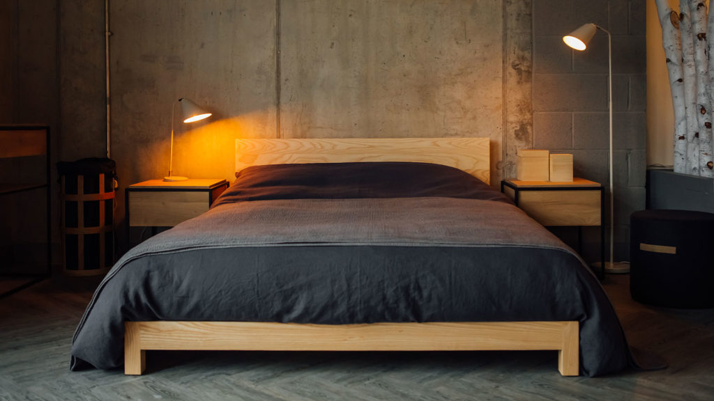 low solid wood Sonora bed base in ash with slate linen-bedding for an industrial look bedroom