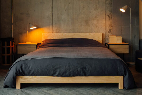 low solid wood Sonora bed base in ash with slate linen-bedding for an industrial look bedroom