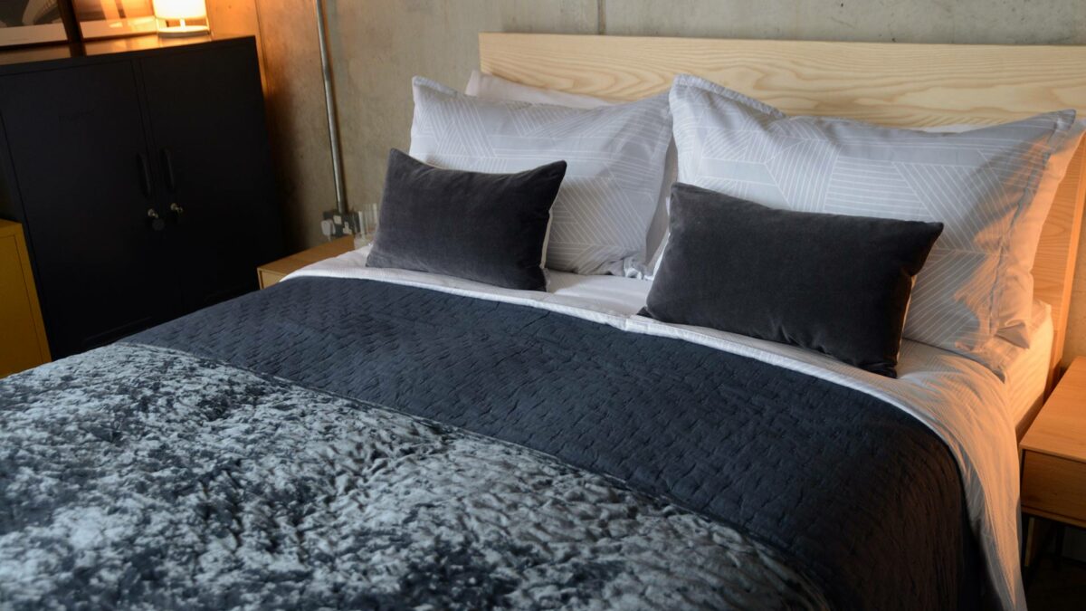 hotel style bedding featuring our crushed velvet bedspread in inky blue/grey