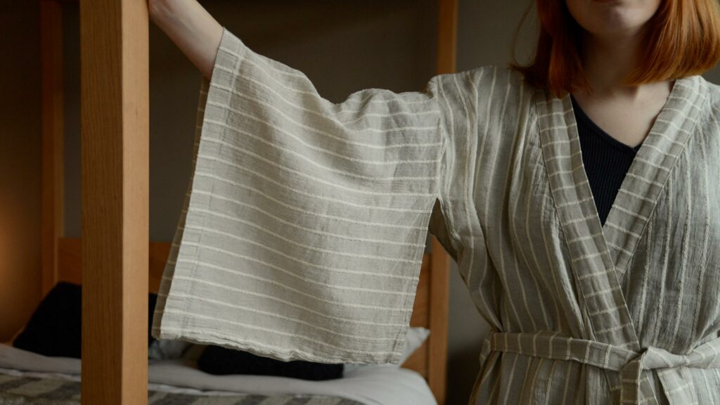 organic linen kimono robe in beige with a textured ivory stripe close up of the sleeves