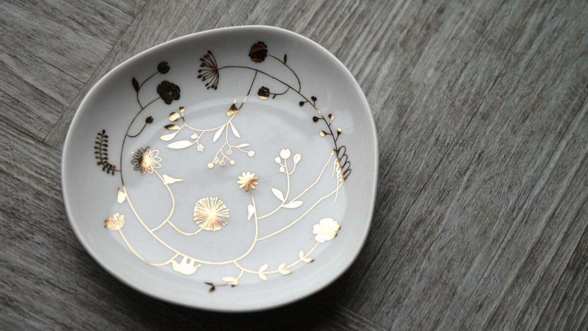 small circular dish with gold flower motifs