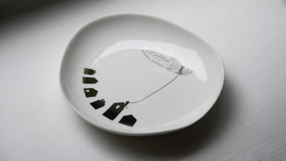 small dish with houses and cloud motif