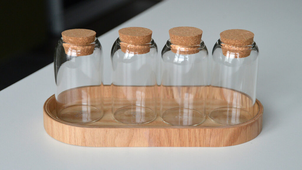 small glass jars in oak tray