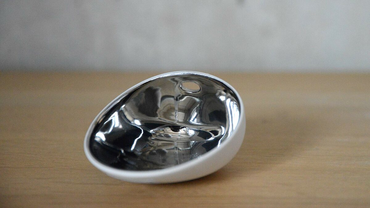 small white porcelain dish with polished silver inner