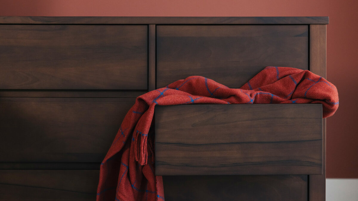 smoke walnut six drawer chest detail with cashmere throw