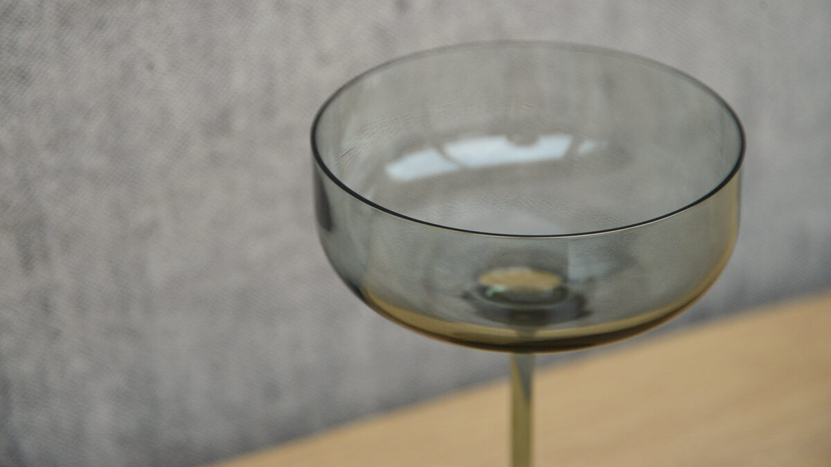 grey smoked glasse champagne saucer glass shown close up