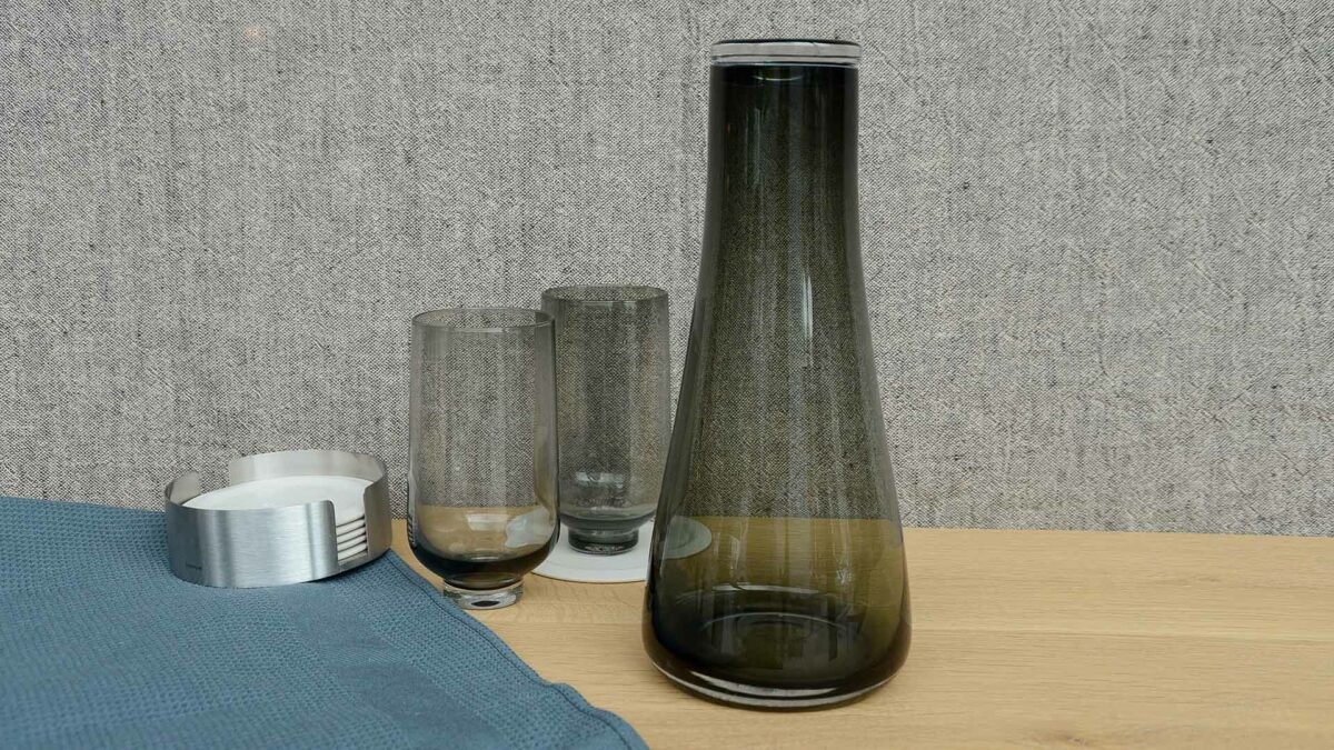 rounded smoked glass carafe shown with smoked glass tumblers