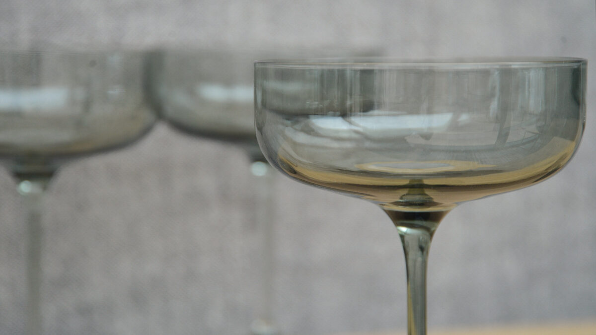 grey smoked glasse champagne saucer glass shown close up