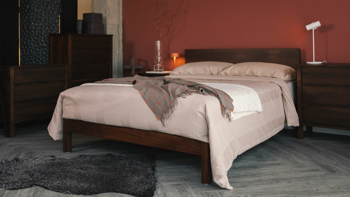 smoked walnut finish Malabar bed with plaster colour bedding and cashemere throw