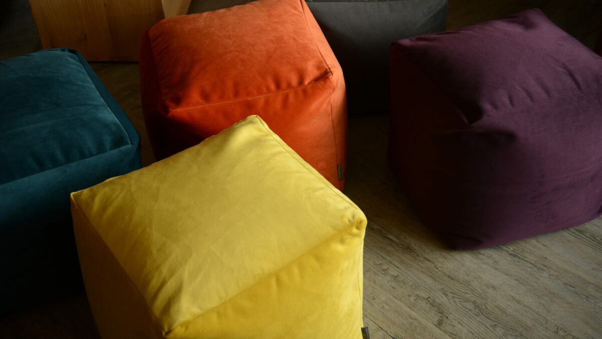 soft cube shaped velvet pouffs in a range of jewel colours