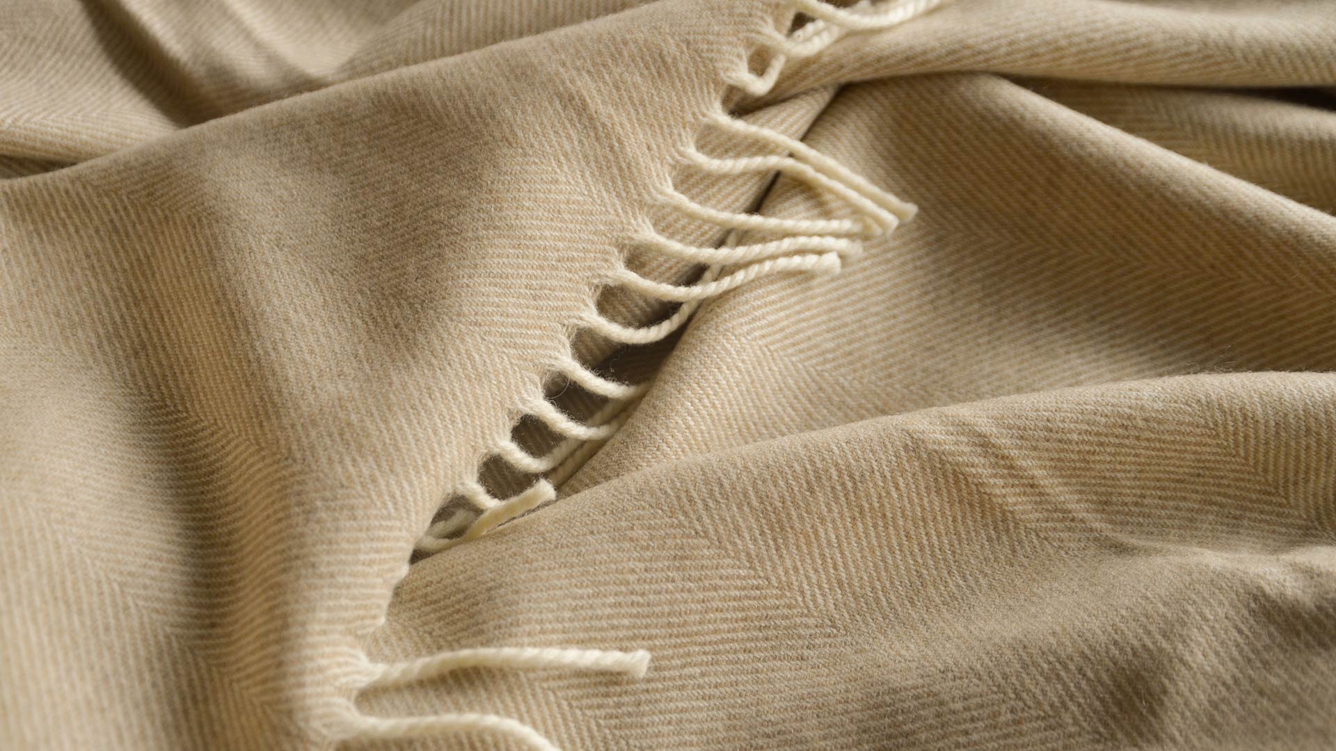 soft merino wool herringbone weave blanket in beige and ivory