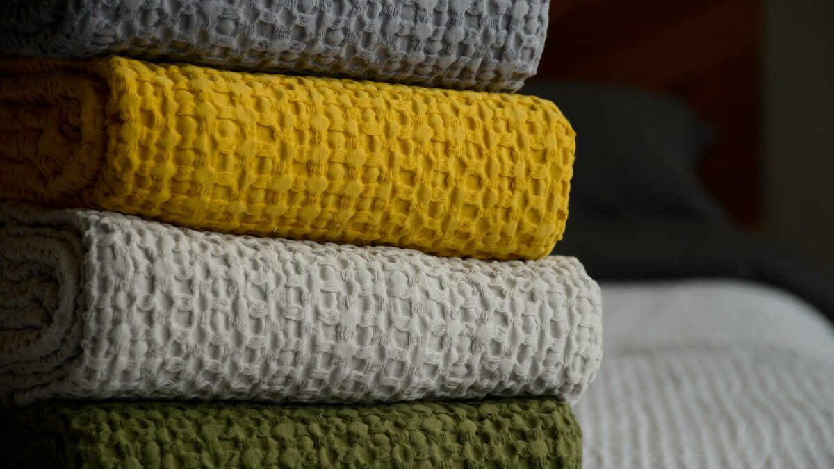 waffle weave cotton throws in a stack of 4 colours