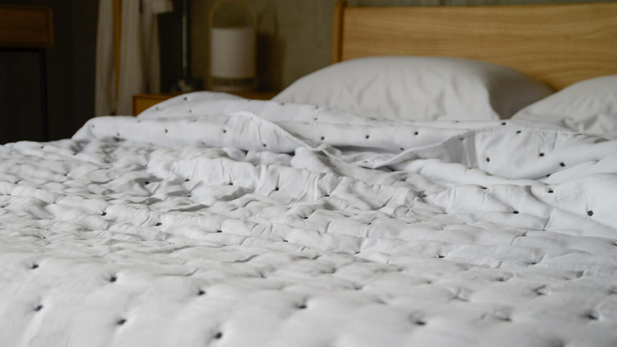 soft white quilt with dark embroidery